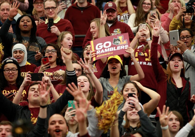Loyola students cheering at basketball game.